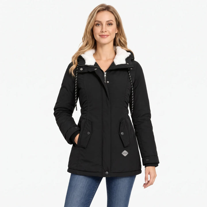 Woman with long blonde hair wears the black jacket zipped over jeans, hand in pocket 1