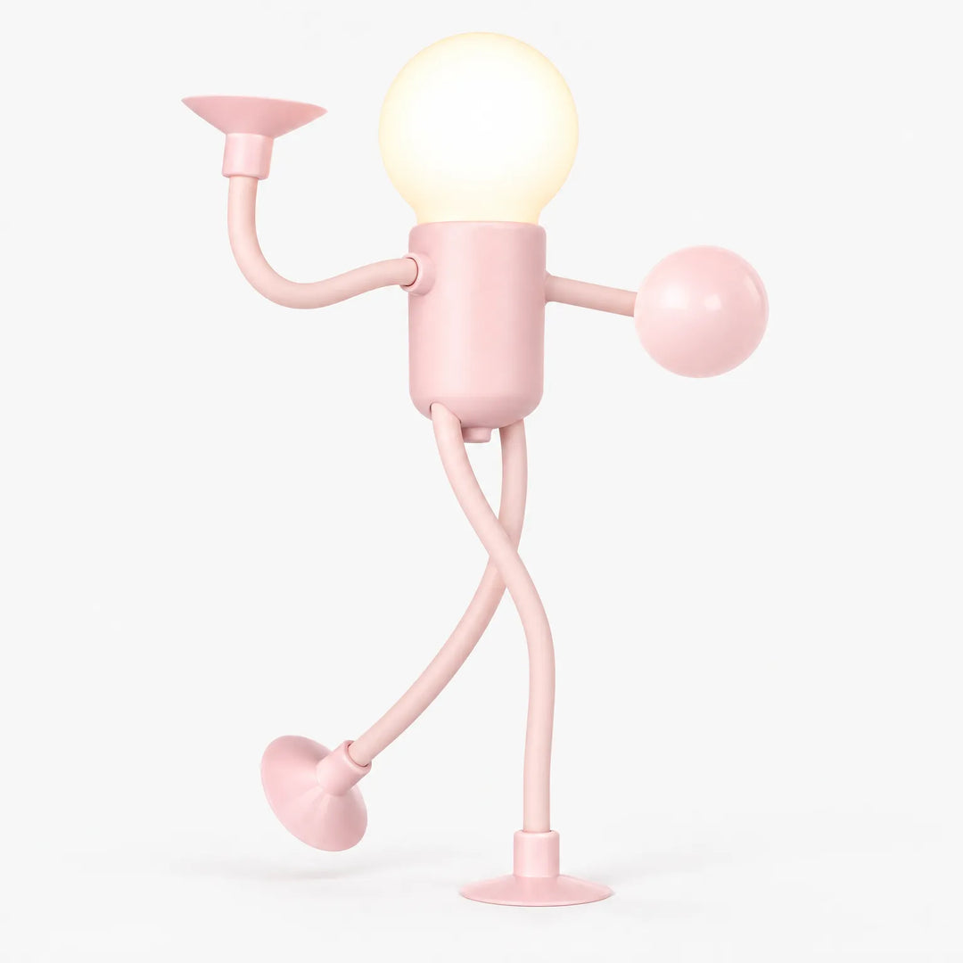 Pink posable figure night light on a plain background, glowing bulb head, bent arms and legs on suction cups 1