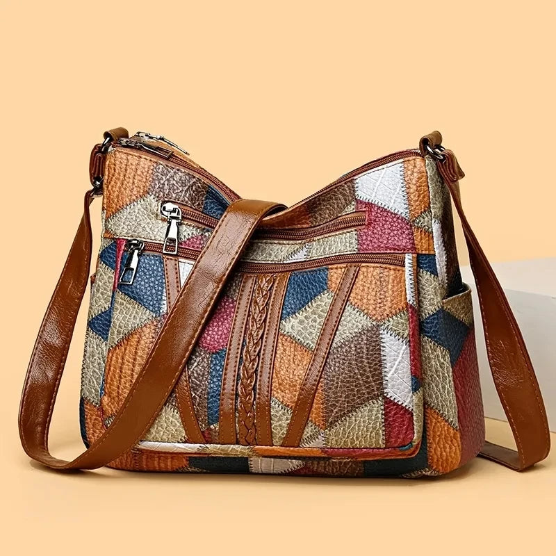 Patchwork bag on a peach backdrop with its long brown strap draped diagonally across the front pockets. 6