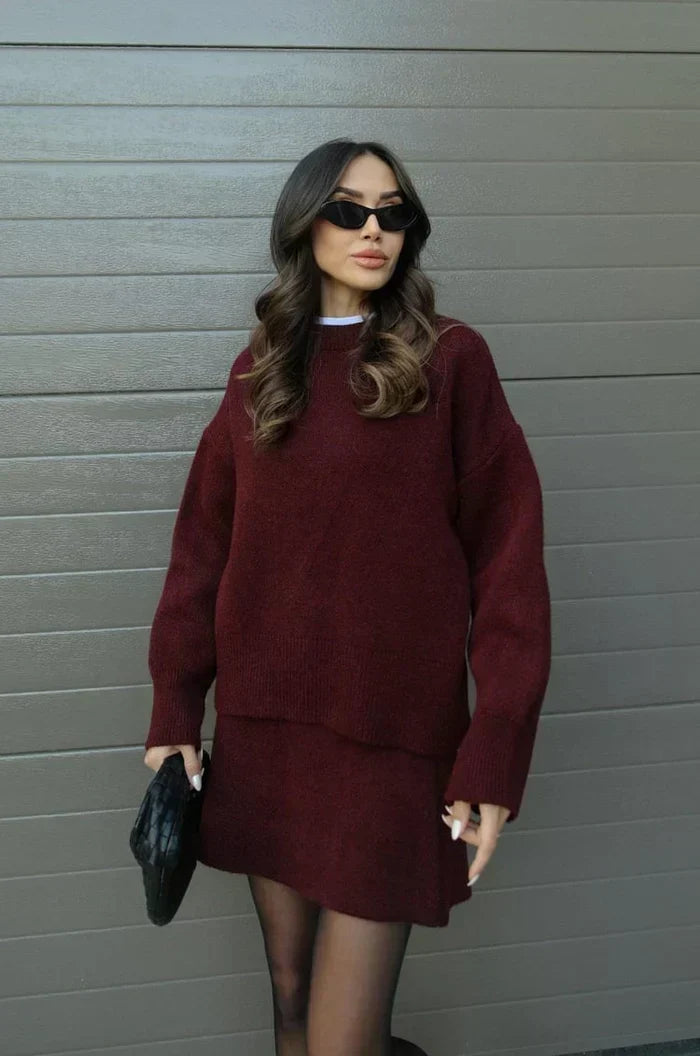 Burgundy sweater and skirt set worn with sheer tights, front view with sunglasses and black clutch 2