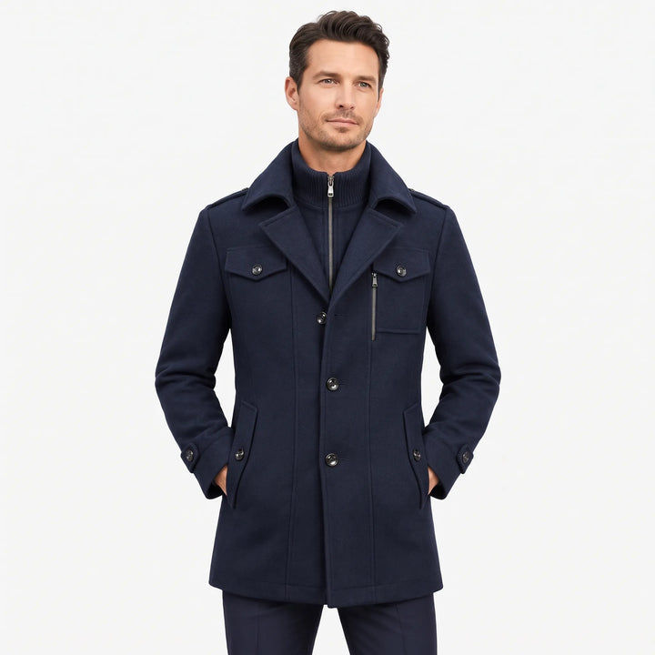 Man wearing the navy overcoat with hands in pockets, showing the zip-in knit collar layer 1
