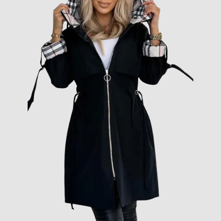 Black coat zipped up with a ring pull, hood folded back to show plaid lining and plaid sleeve cuffs.