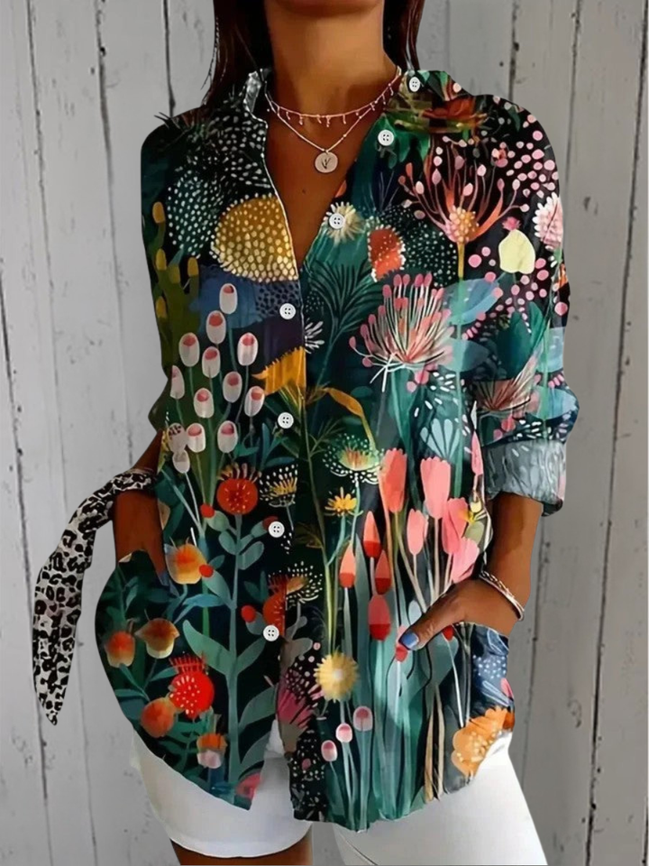 Anica blouse detail with a dark green print of stylized wildflowers, tulips and dotted blooms.