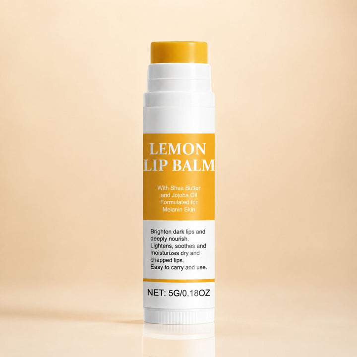 Lemon Lip Balm stick with a yellow balm tip and an orange label on a peach background.