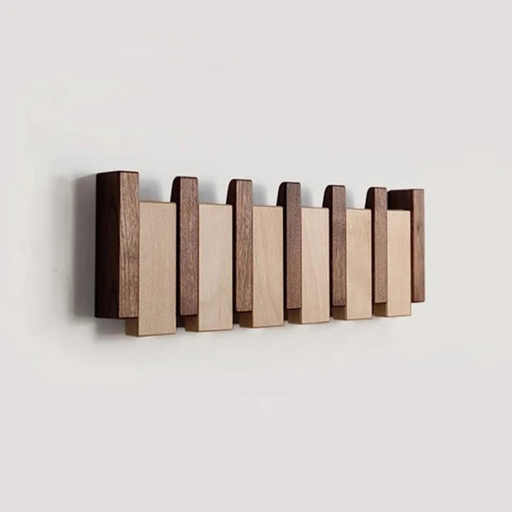 Short six-slat rack in dark and light wood with all hooks folded flat, shown empty on a pale wall.