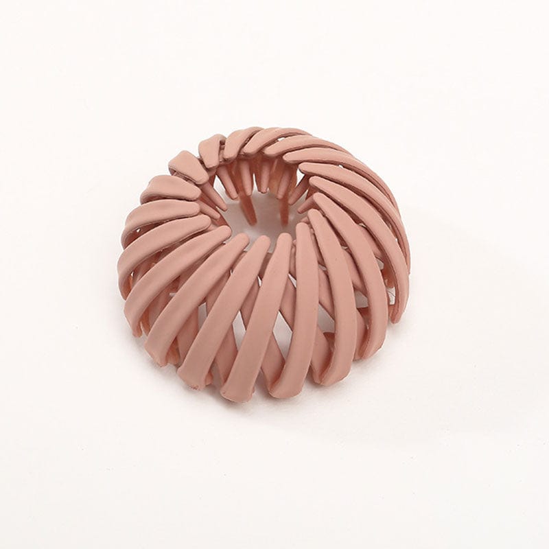 Twist-and-snap hair clip in terracotta pink velvet shown from above.