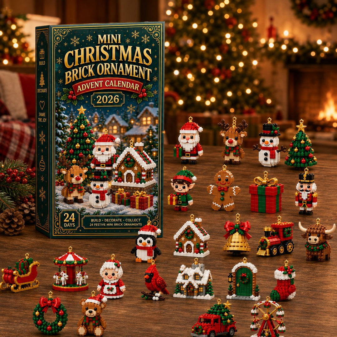 Box beside all 24 finished ornaments spread across a wooden table, with a lit tree and fireplace glowing in the background.