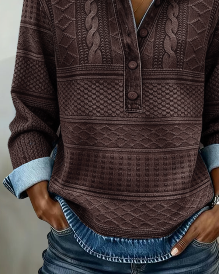 Women's brown patterned sweatshirt detail with button front and textured hem.