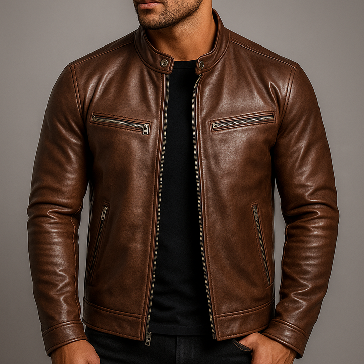 Man wearing the brown leather jacket unzipped over a black T-shirt, showing the stand collar, chest zip pockets and cuff tabs. 3