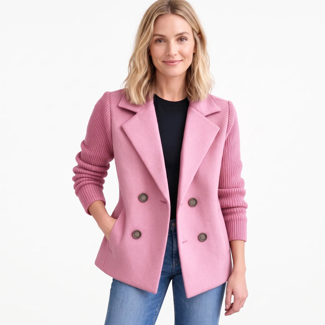 Model wearing pink jacket with ribbed knit sleeves and gray buttons, hand in pocket, with jeans 20