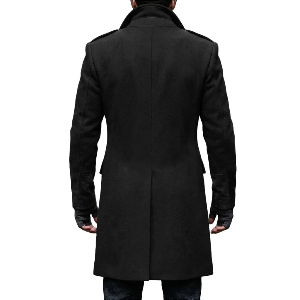 Back view of the black overcoat on a model, showing the center vent, collar and shoulder epaulettes 20