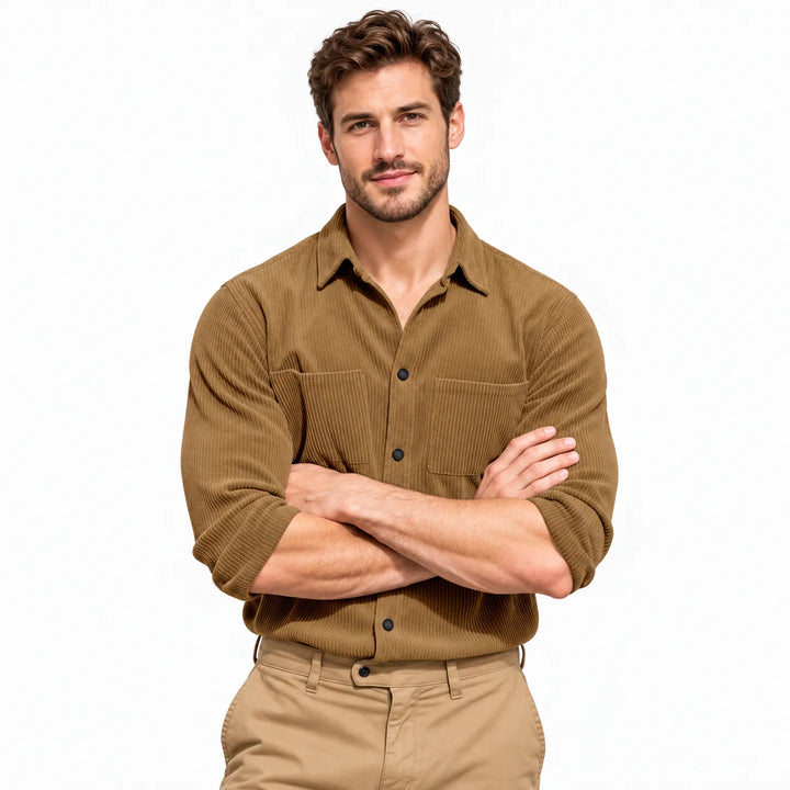 Smiling model with arms crossed wearing the tan ribbed button shirt and khaki pants against white 20