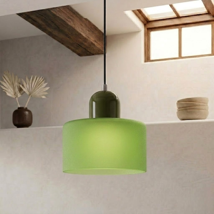 Frosted green drum shade with a dark olive green dome cap hangs from a black cord beside a window. 25