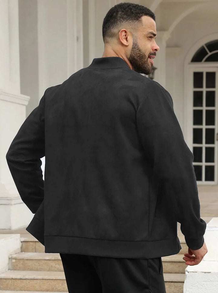Back view of a man wearing the black jacket, standing on steps beside white columns 20