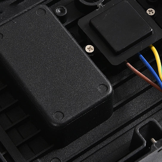 Close-up of the lamp's interior with a black driver box, a small square module, and brown, blue and yellow wires. 7