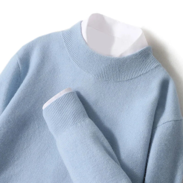 Close-up of the light blue knit sweater's ribbed mock neck and cuff over a white shirt 21