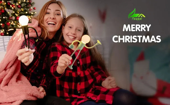 Smiling mother and daughter in red plaid shirts hold posable bulb-head figure lights near a Christmas tree 21