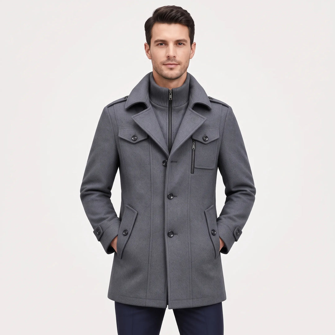 Man wearing the gray button-up overcoat with a ribbed zip inner collar, hands in pockets, front view 21