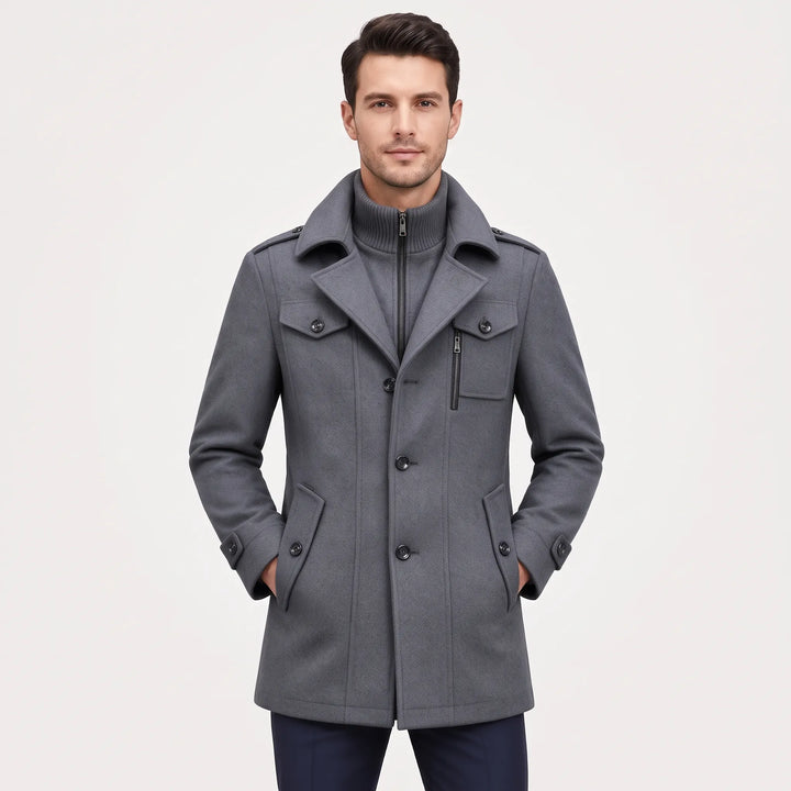 Man wearing the gray button-up overcoat with a ribbed zip inner collar, hands in pockets, front view 21