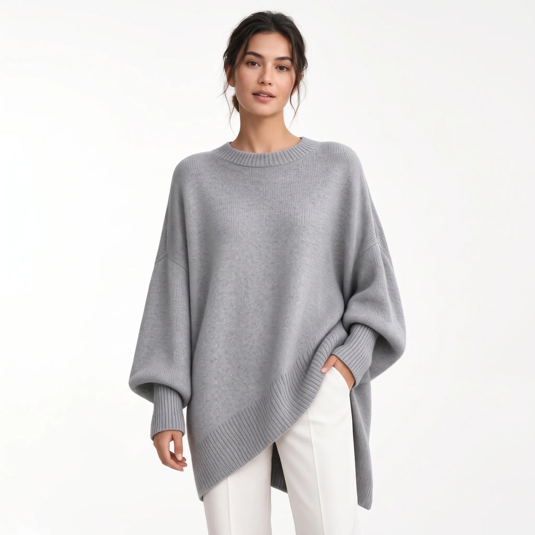 Woman wearing the oversized gray knit sweater with ribbed cuffs and hem, one hand in white trouser pocket 21