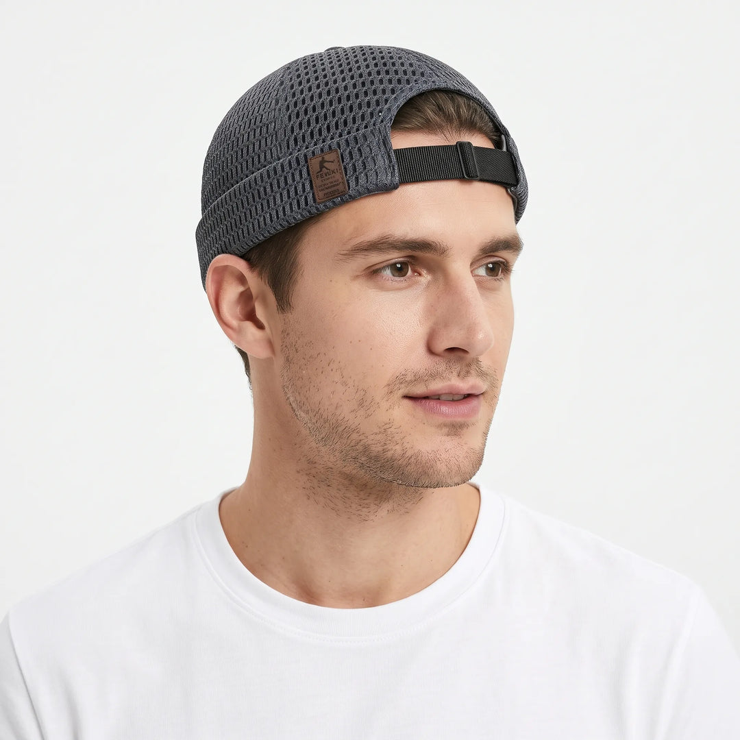 Man in a white tee wears the dark gray open-weave cap, showing its adjustable black rear strap 21