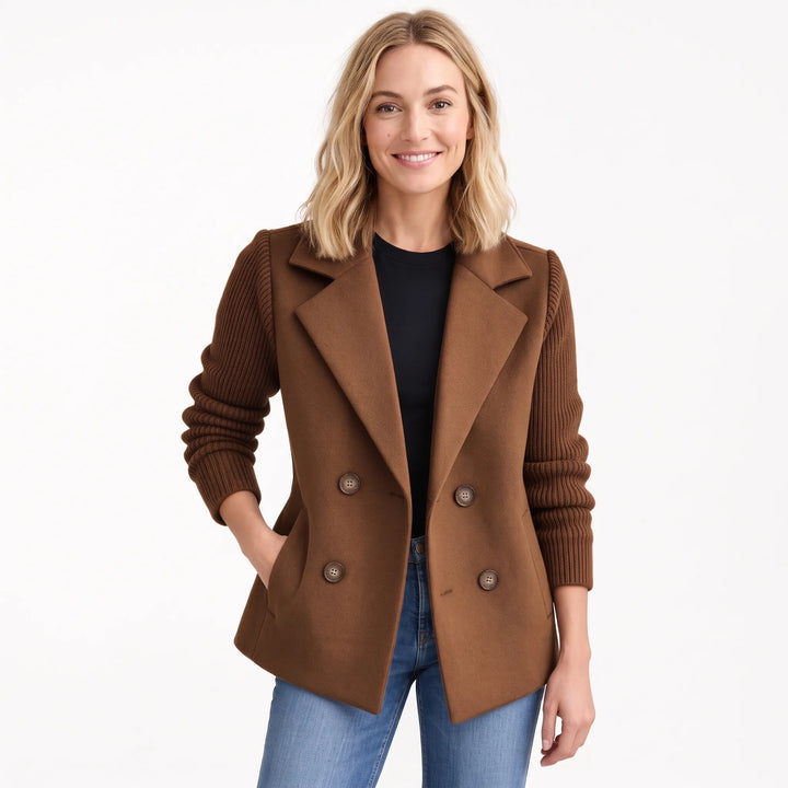 Woman smiling in the brown version of the jacket with ribbed knit sleeves, worn open over black top and jeans 22