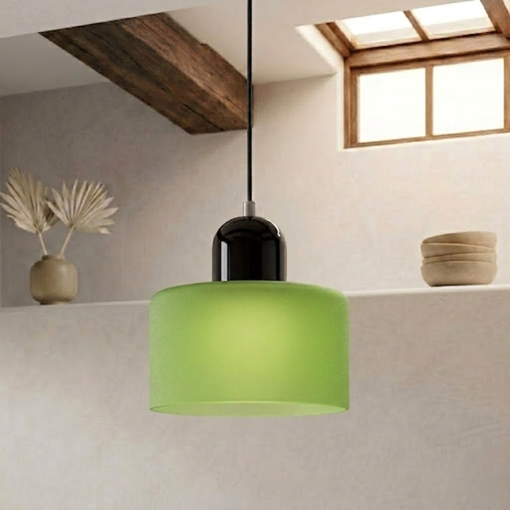 Frosted green drum shade with a black dome cap hangs from a black cord against a plaster wall. 27