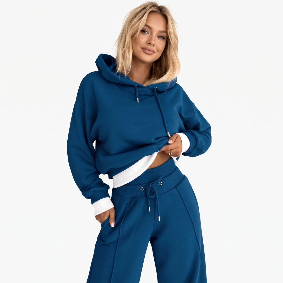 Model wearing the blue hooded set with white ribbed hem and cuffs, front view 22