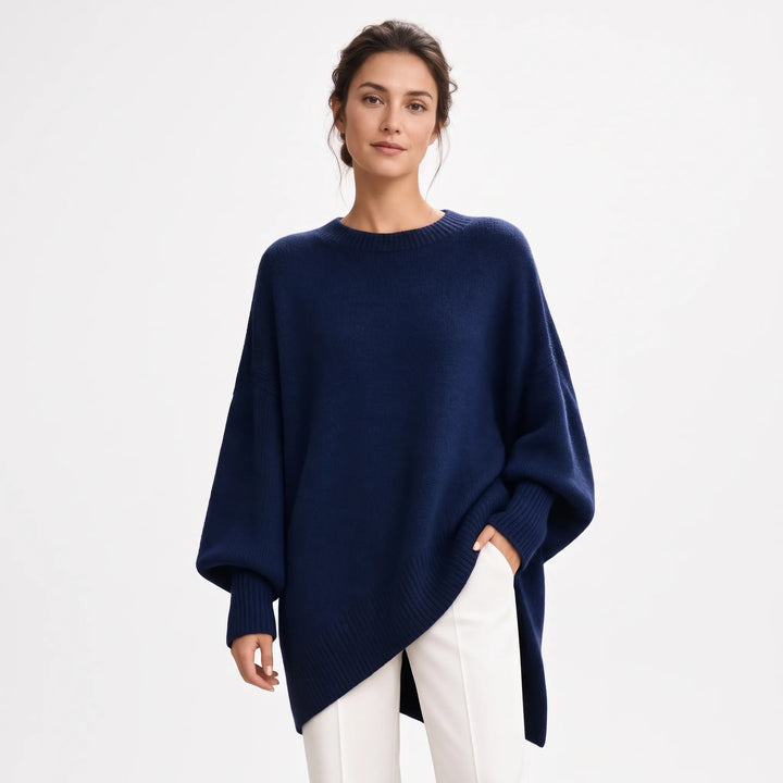 Woman wearing the oversized navy knit sweater with balloon sleeves and ribbed trim, paired with white trousers 22