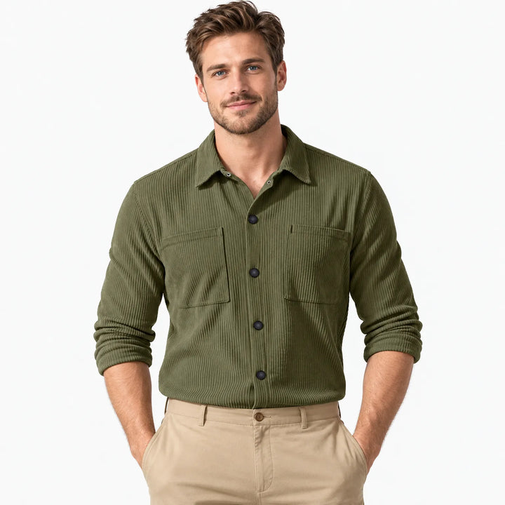 Man wearing an olive green ribbed corduroy shirt with two chest pockets, hands in khaki pants pockets 22