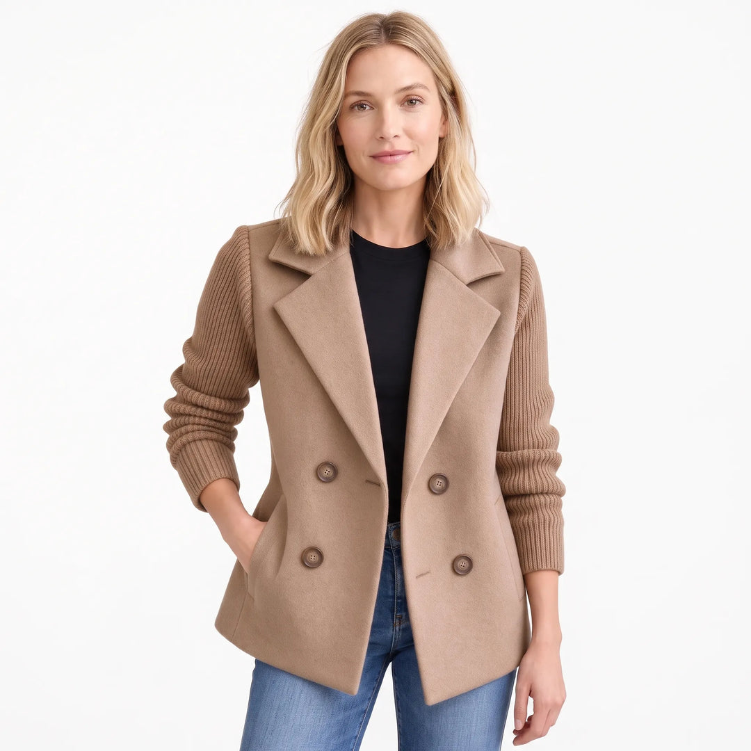 Woman wearing the camel-beige version of the jacket open, with ribbed knit sleeves, black top and jeans 23