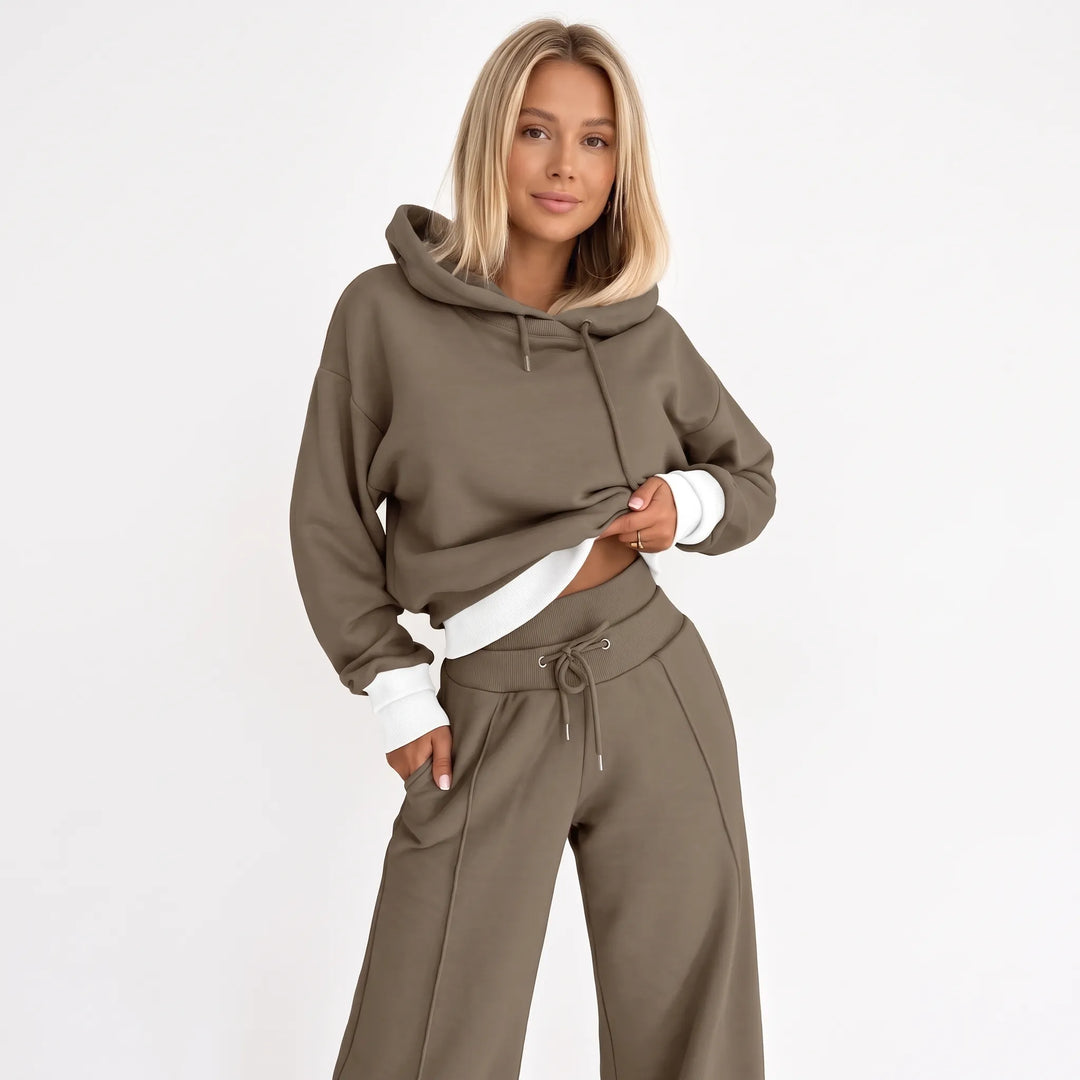 Model wearing the brown-taupe hooded set with white ribbed hem and cuffs, front view 23