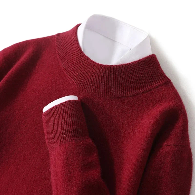 Close-up of the burgundy knit sweater's ribbed mock neck and cuff over a white shirt 23