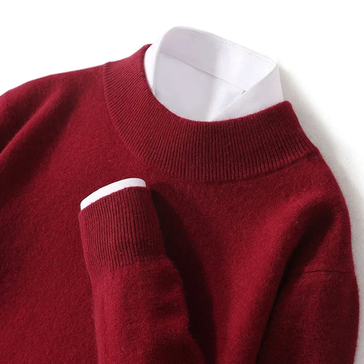 Close-up of the burgundy knit sweater's ribbed mock neck and cuff over a white shirt 23