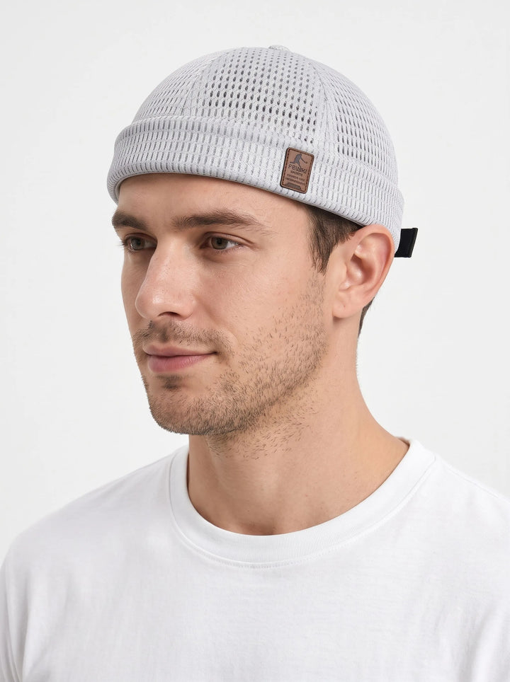 Man in a white tee wears the light gray open-weave brimless cap with a small leather patch 23