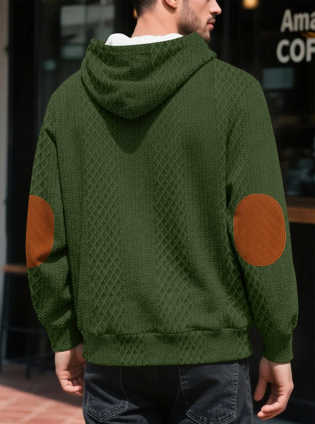 Back view of the olive green hoodie on a man, showing large brown elbow patches 23