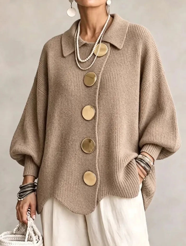 Camel brown ribbed cardigan worn by a model, showing gold buttons, pointed collar and loose balloon sleeves. 7