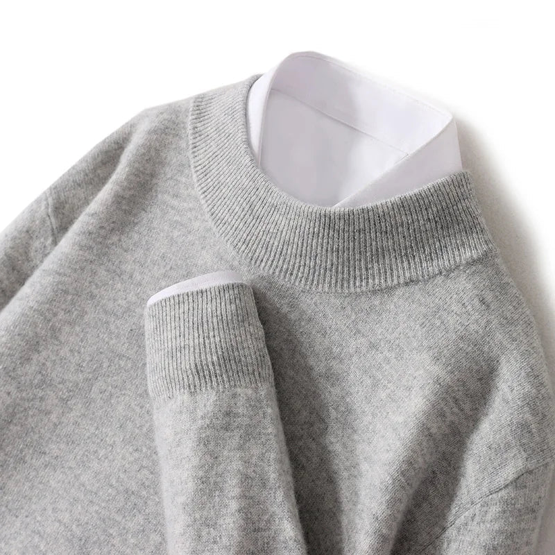 Close-up of the light gray knit sweater's ribbed mock neck and cuff over a white shirt 24
