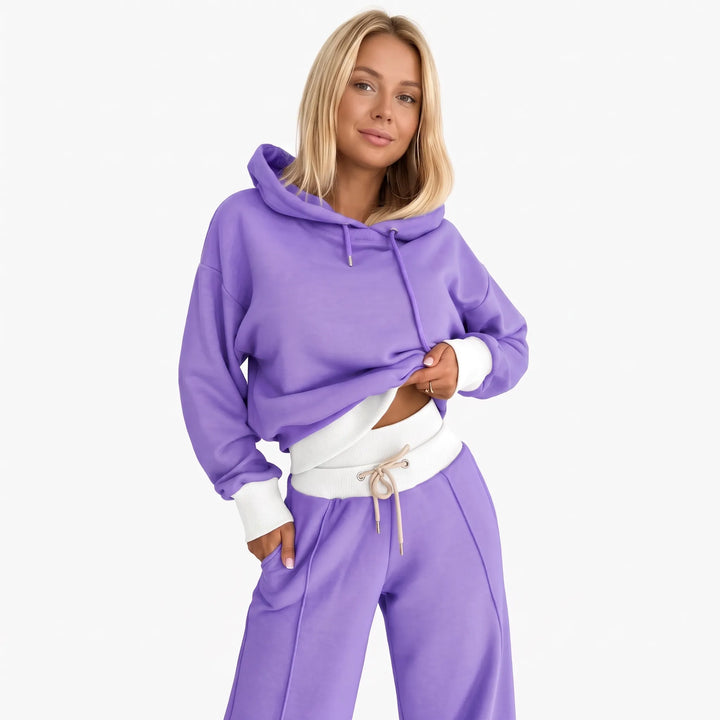 Model wearing the purple hooded set with white ribbed hem, cuffs and waistband, front view 24