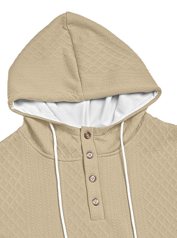 Close-up of the beige textured hood and four-button placket with white drawstrings 24