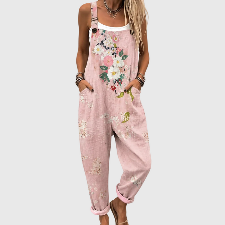 Pink floral overalls with adjustable straps and side pockets, worn over a white tank.
