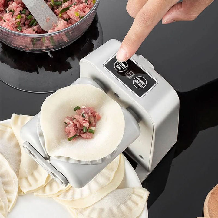 A finger presses a button on the control panel while a filled dough round sits on the molding rollers, with a bowl of filling nearby. 2