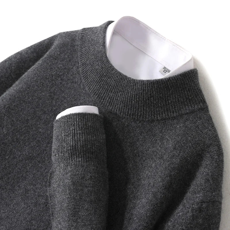 Close-up of the charcoal knit sweater's ribbed mock neck and cuff over a white shirt 26