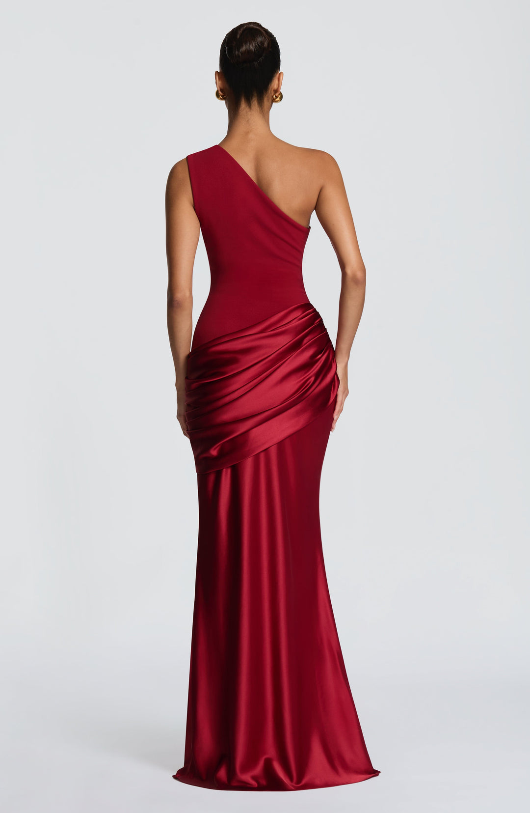 Back view of the deep red gown, showing the asymmetric strap and draped satin detail at the hip. 18