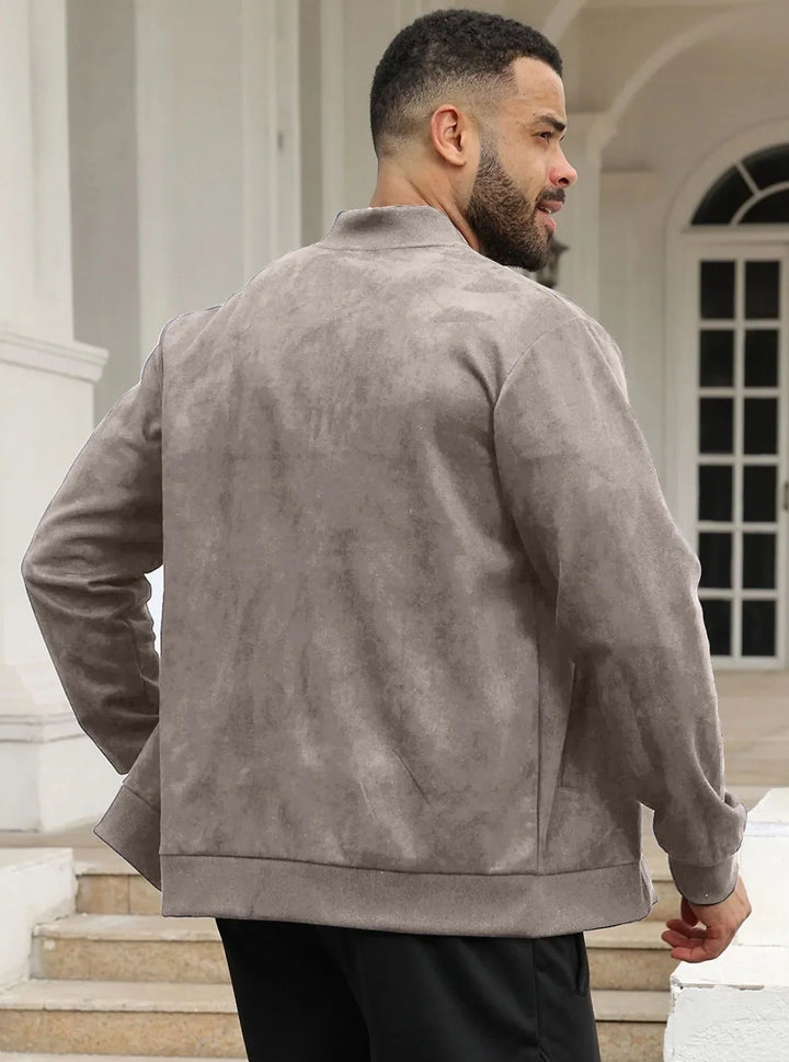 Man in taupe suede-look bomber jacket seen from behind, standing on steps by white columns 28