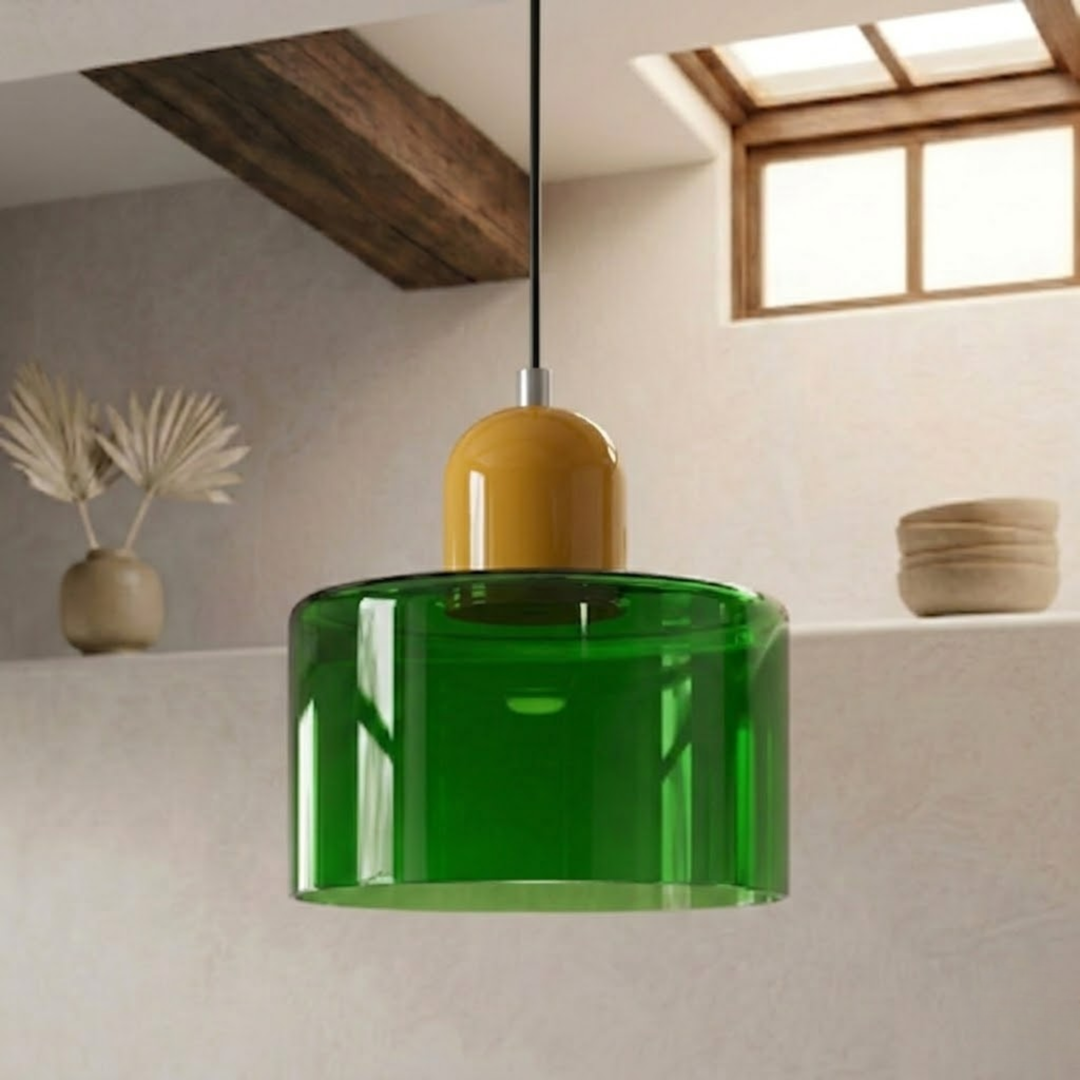 Translucent green glass shade with a mustard yellow dome cap hangs on a black cord in a rustic setting. 34