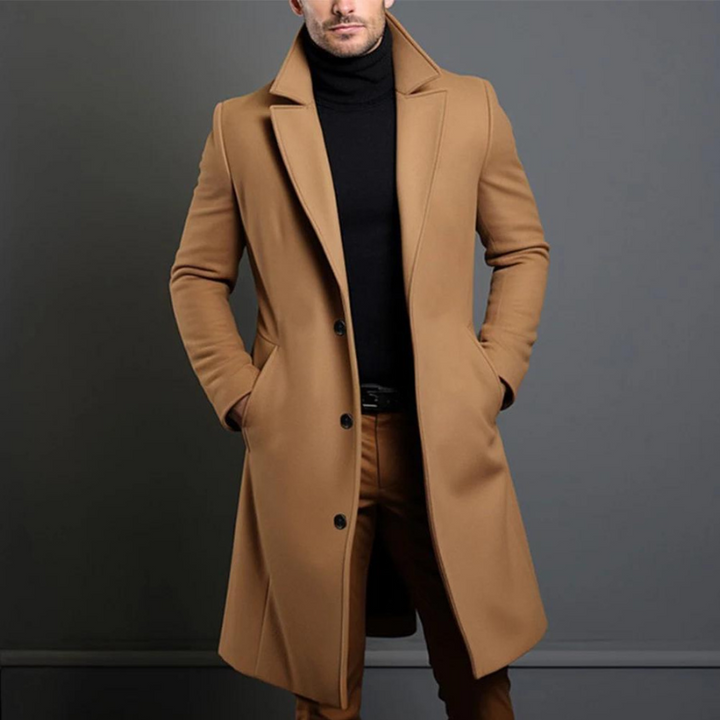 Camel longline coat with wide notch lapels and three buttons, styled with a black turtleneck and brown trousers, cropped view of the torso. 2