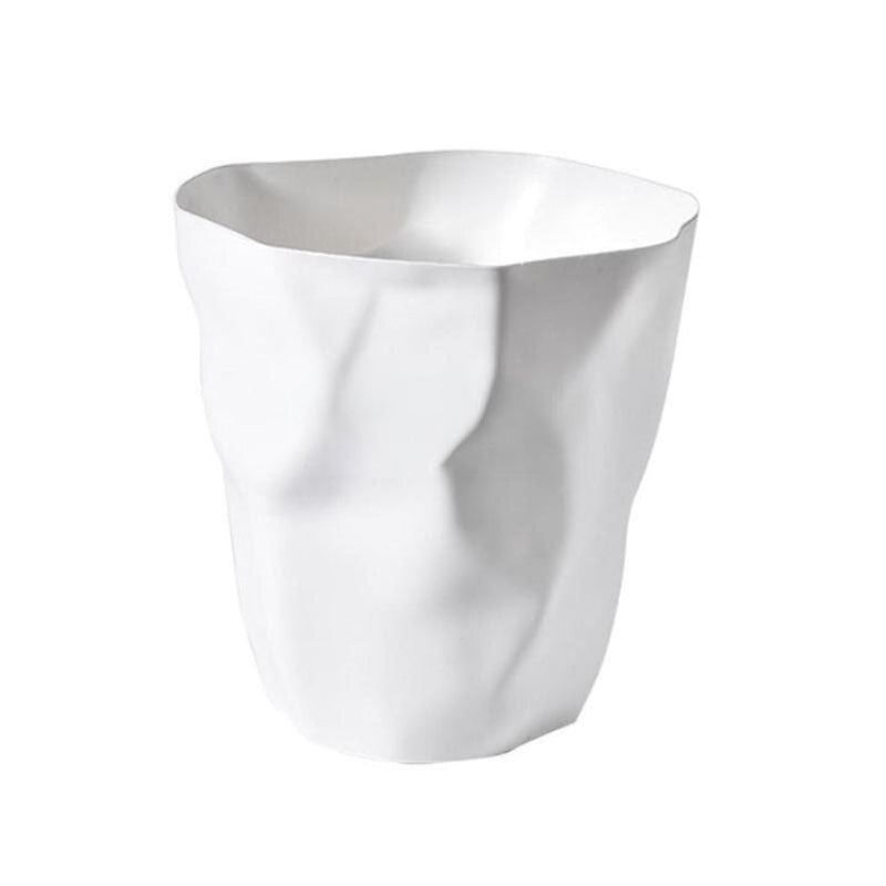 White wastebasket with a sculptural crumpled paper design and deep creased folds.