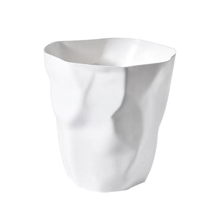 White wastebasket with a sculptural crumpled paper design and deep creased folds.