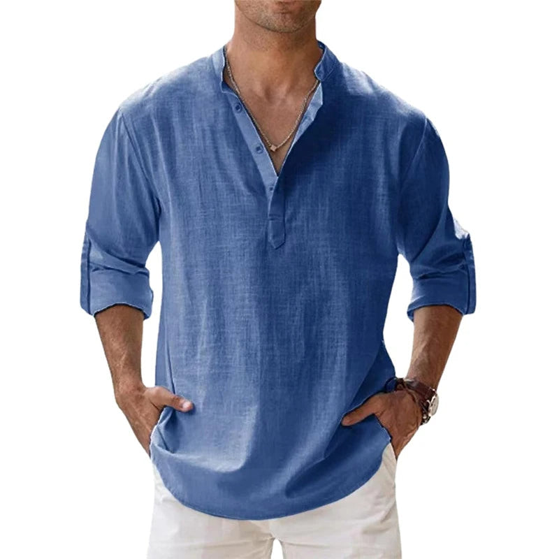 Men's linen Henley shirt in medium blue with rolled sleeves and a button neck.